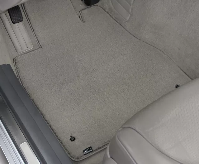 A grey carpet mat installed on vehicle’s floor